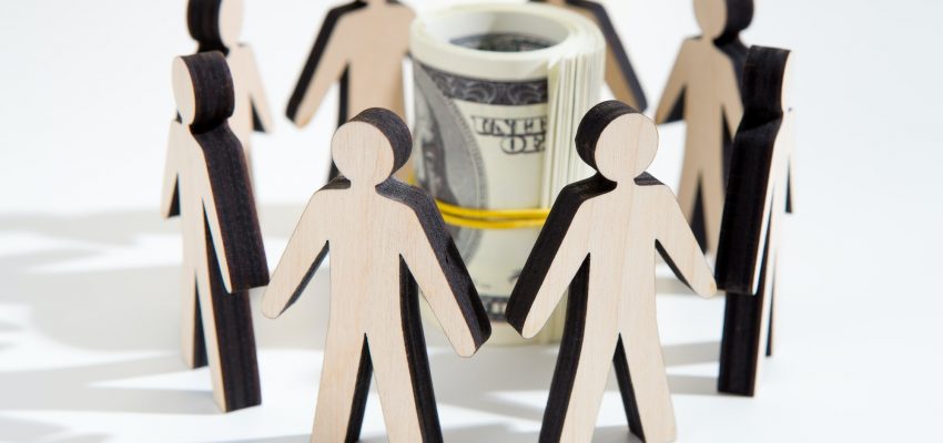 Close up of investors around savings deciding where to invest