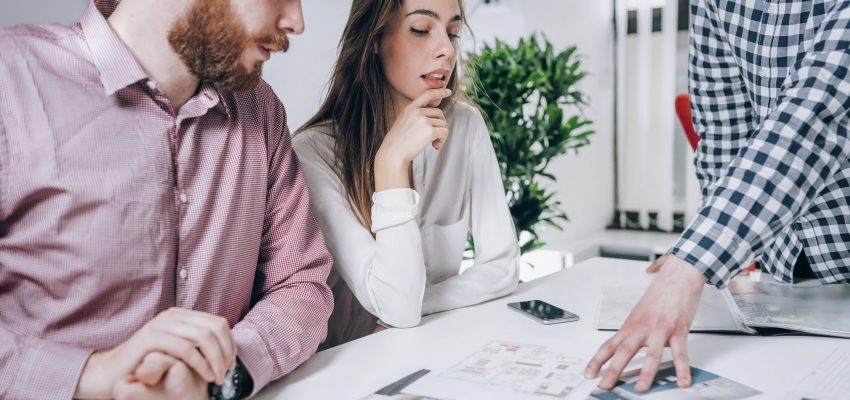 Couple in Real-Estate Agency Talking to Real Estate Agent